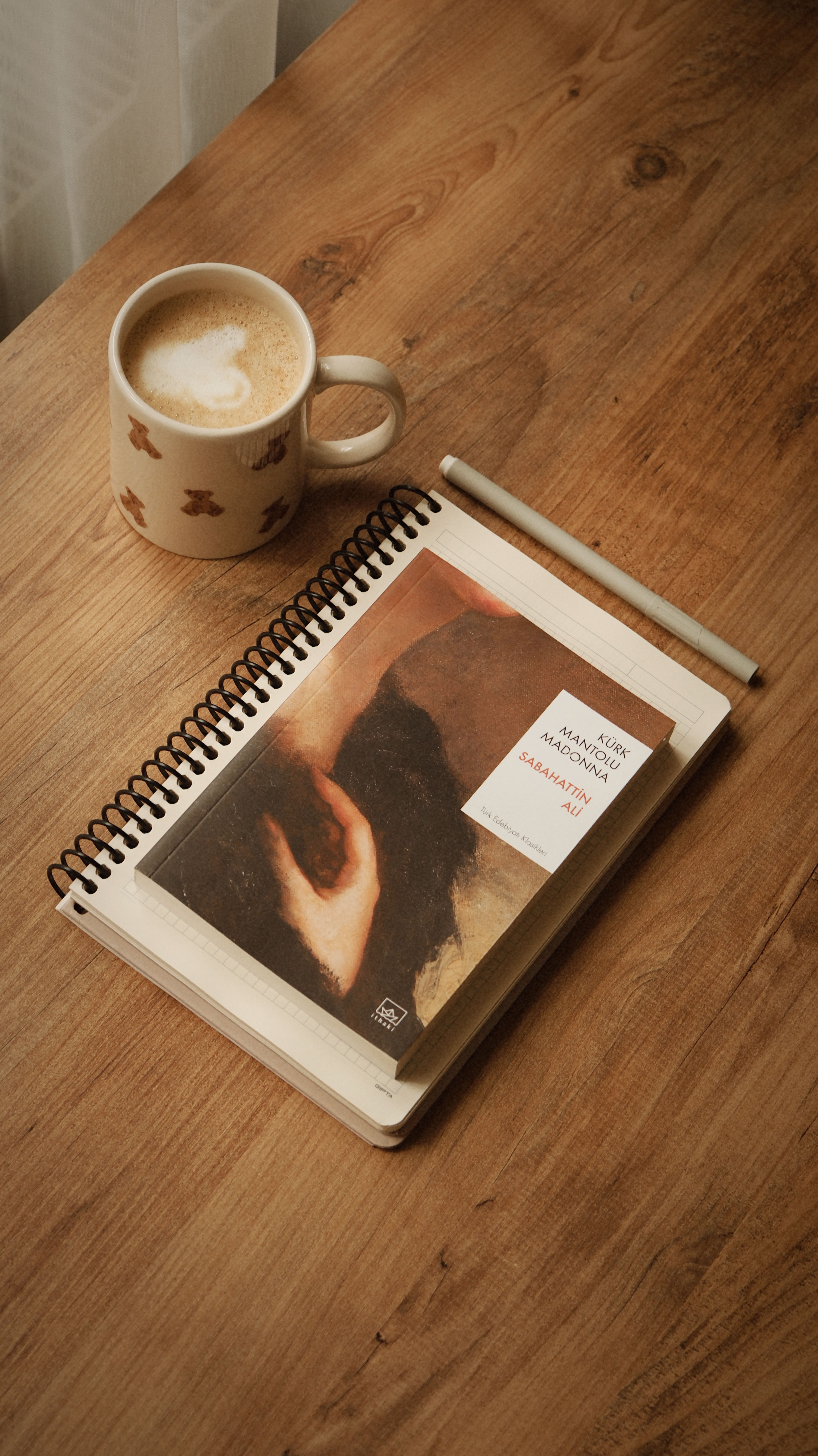 A serene setting of a book and coffee on a rustic wooden table, perfect for relaxation.
