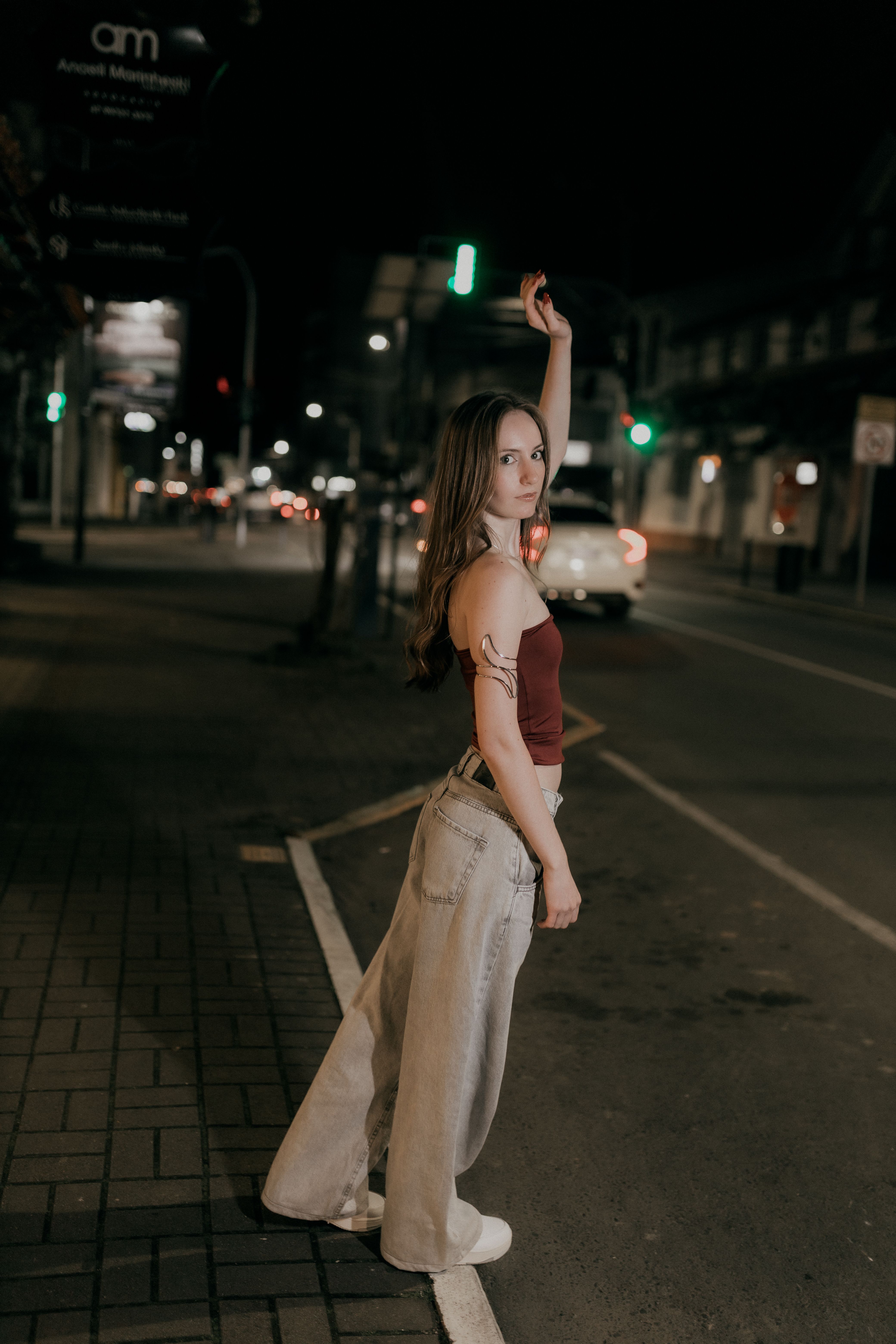 Young Woman Posing on City Street at Night · Free Stock Photo