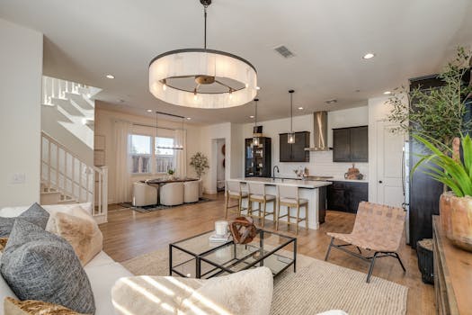 Sleek and stylish modern kitchen and living room with elegant decor and natural lighting.