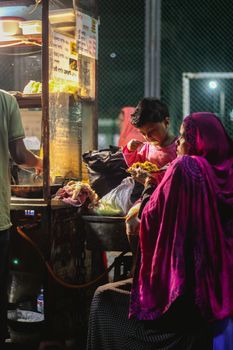 Vibrant night market scene in Dhaka showcasing local culture and street food.