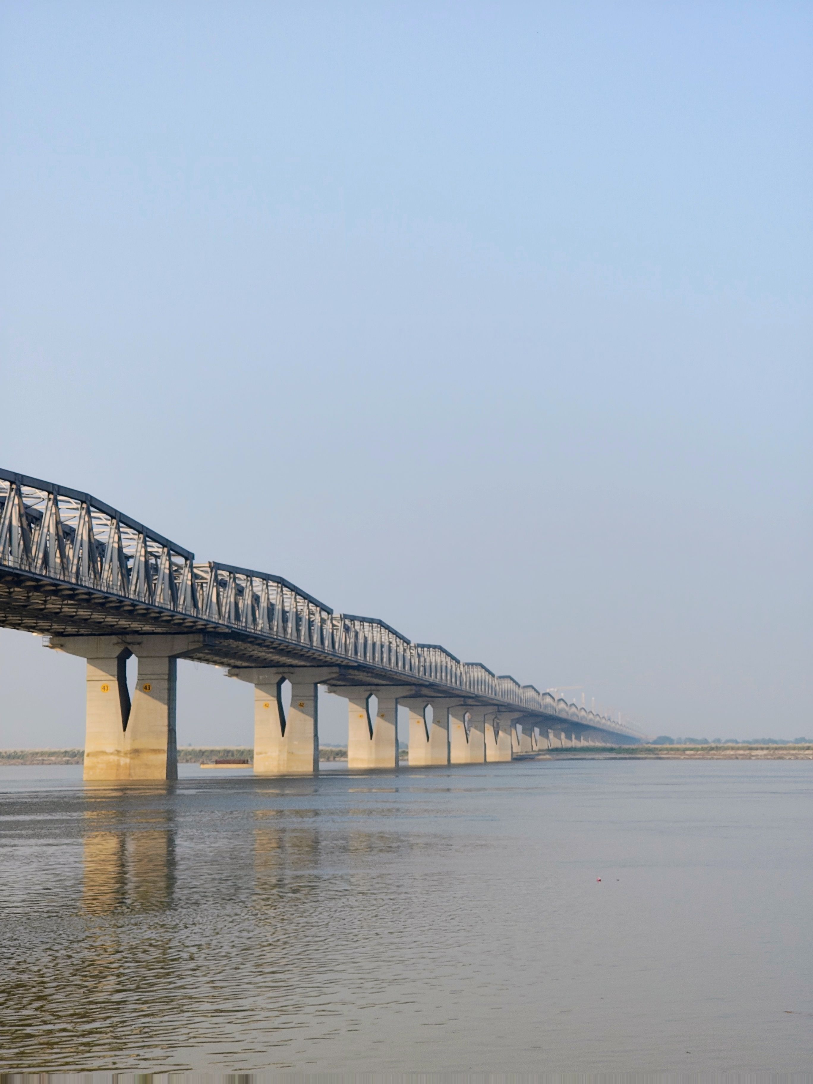 Majestic Steel Bridge Spanning a Calm River · Free Stock Photo
