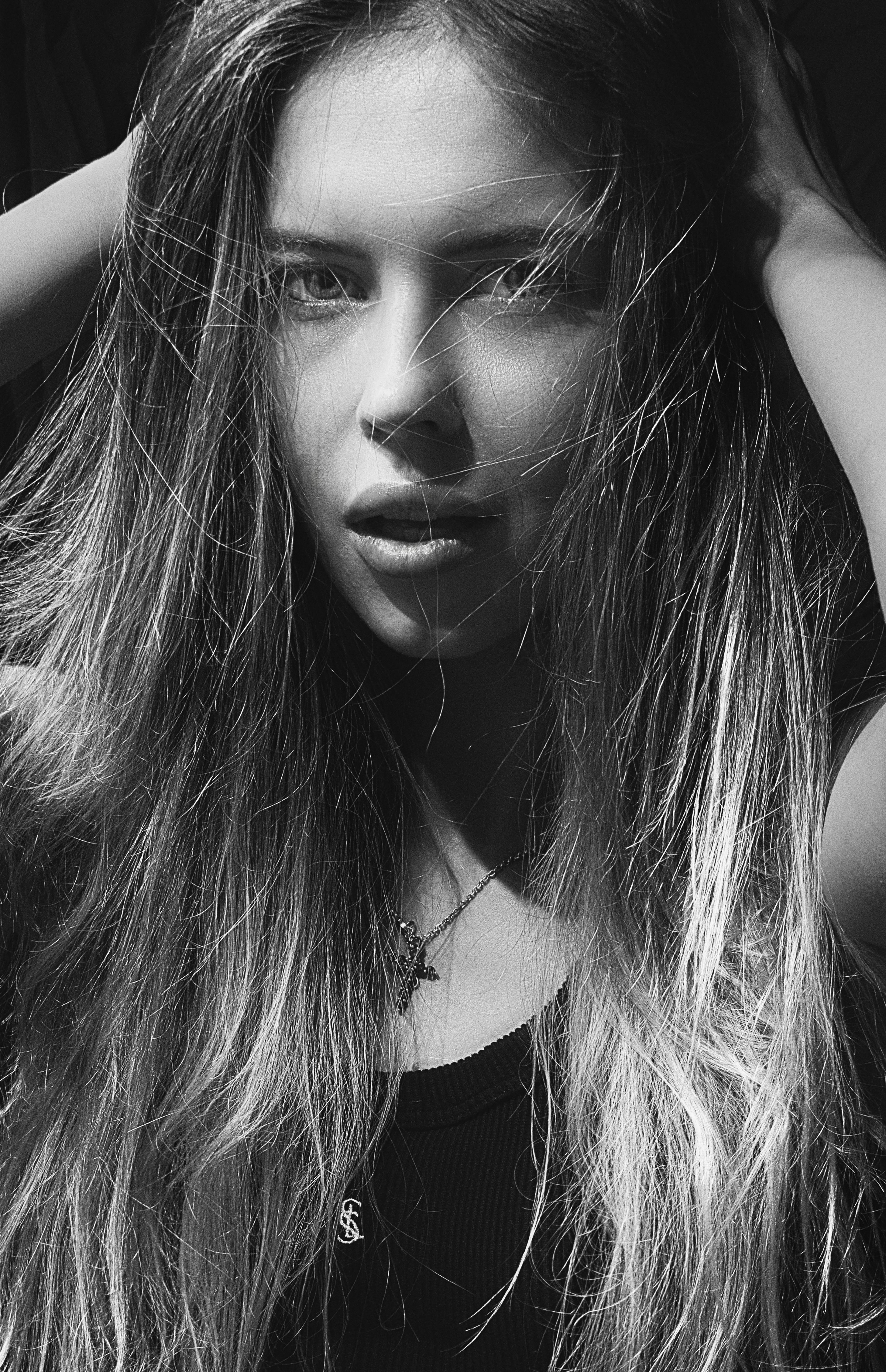 Dramatic black and white portrait of a woman with long hair.