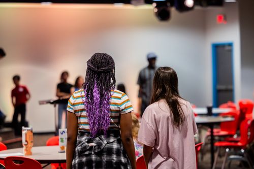 Free Group of teenagers participating in a social event indoors with focus on diversity and interaction. Stock Photo