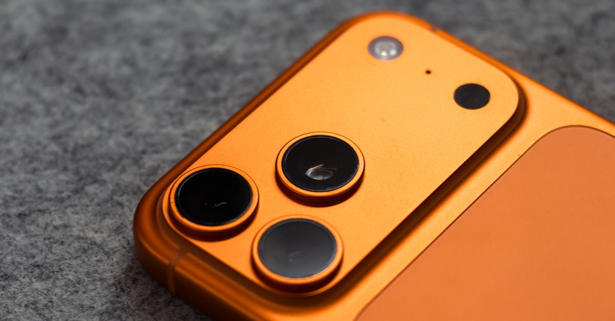 Close-Up of Orange Smartphone on Gray Surface · Free Stock Photo