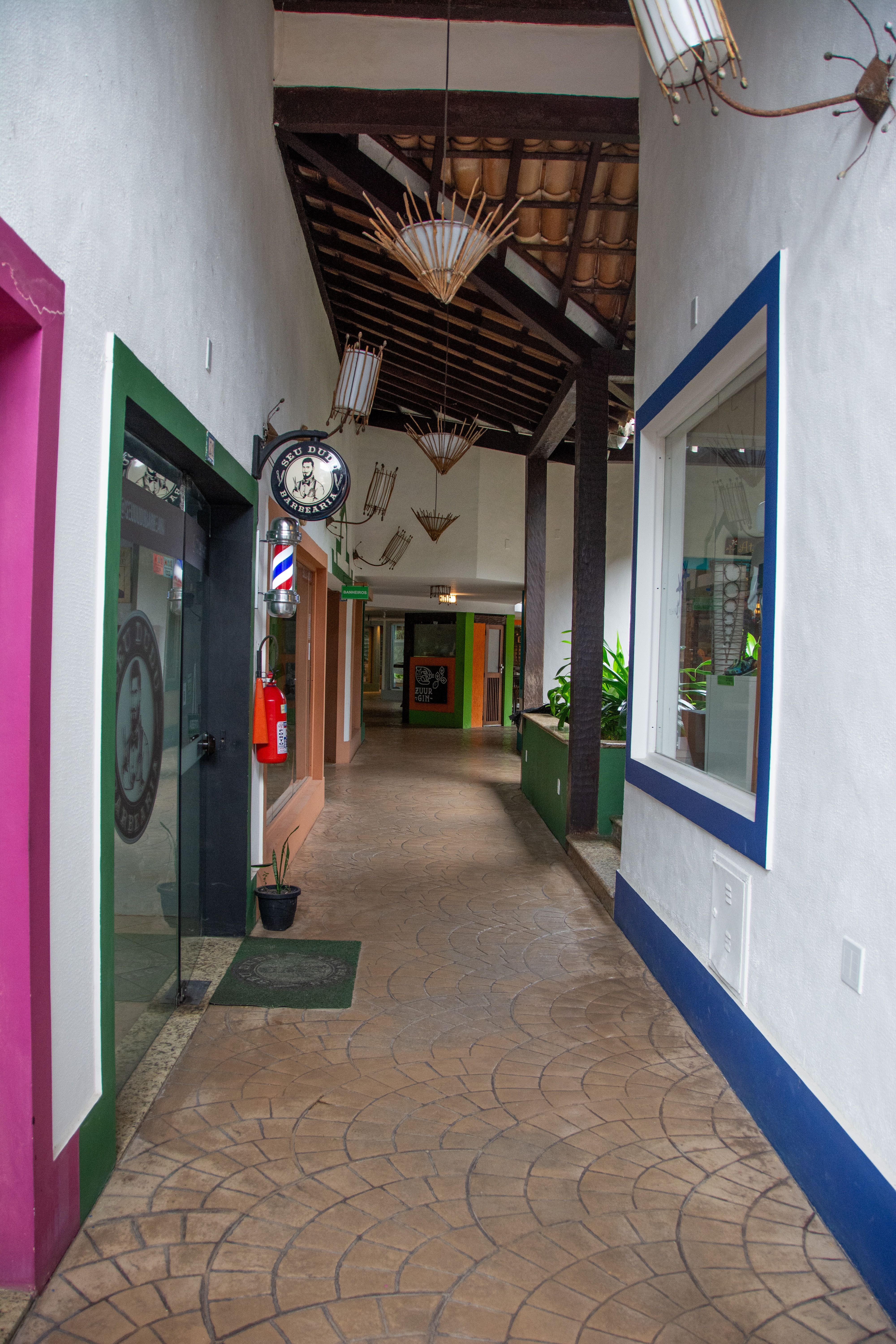 Quaint corridor with colorful walls in Arraial d'Ajuda, a vibrant Bahian village.