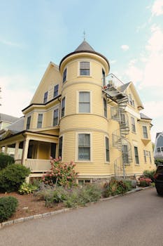Elegant Victorian house with a spiral staircase and vibrant garden.