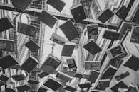 Grayscale Photo of Hanging Books