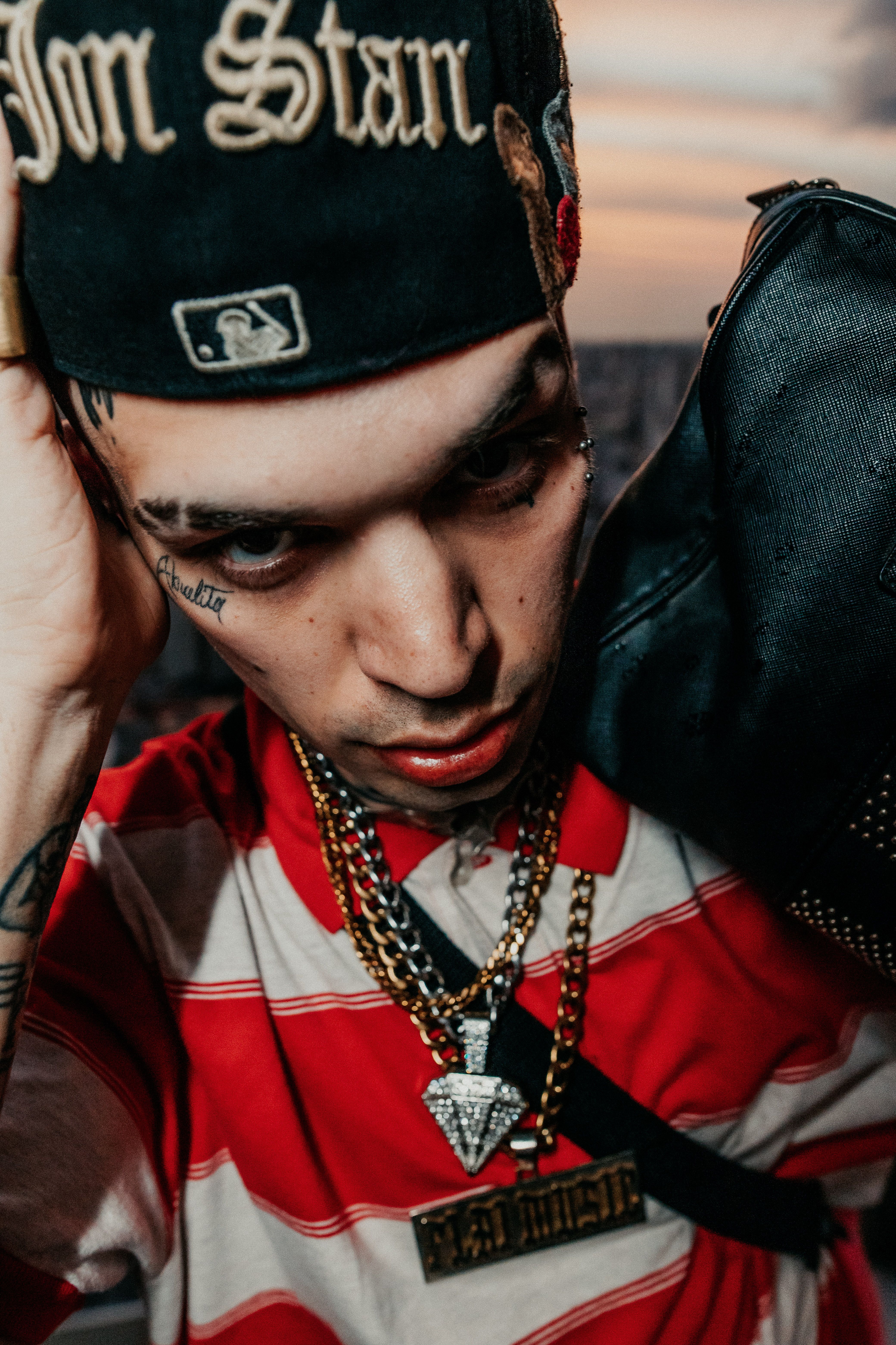 Close-up of a fashionable young man with tattoos and chains in Buenos Aires.
