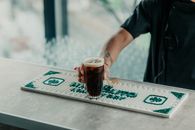 A bartender serves a fernet cocktail over a bar mat in Buenos Aires, Argentina.
