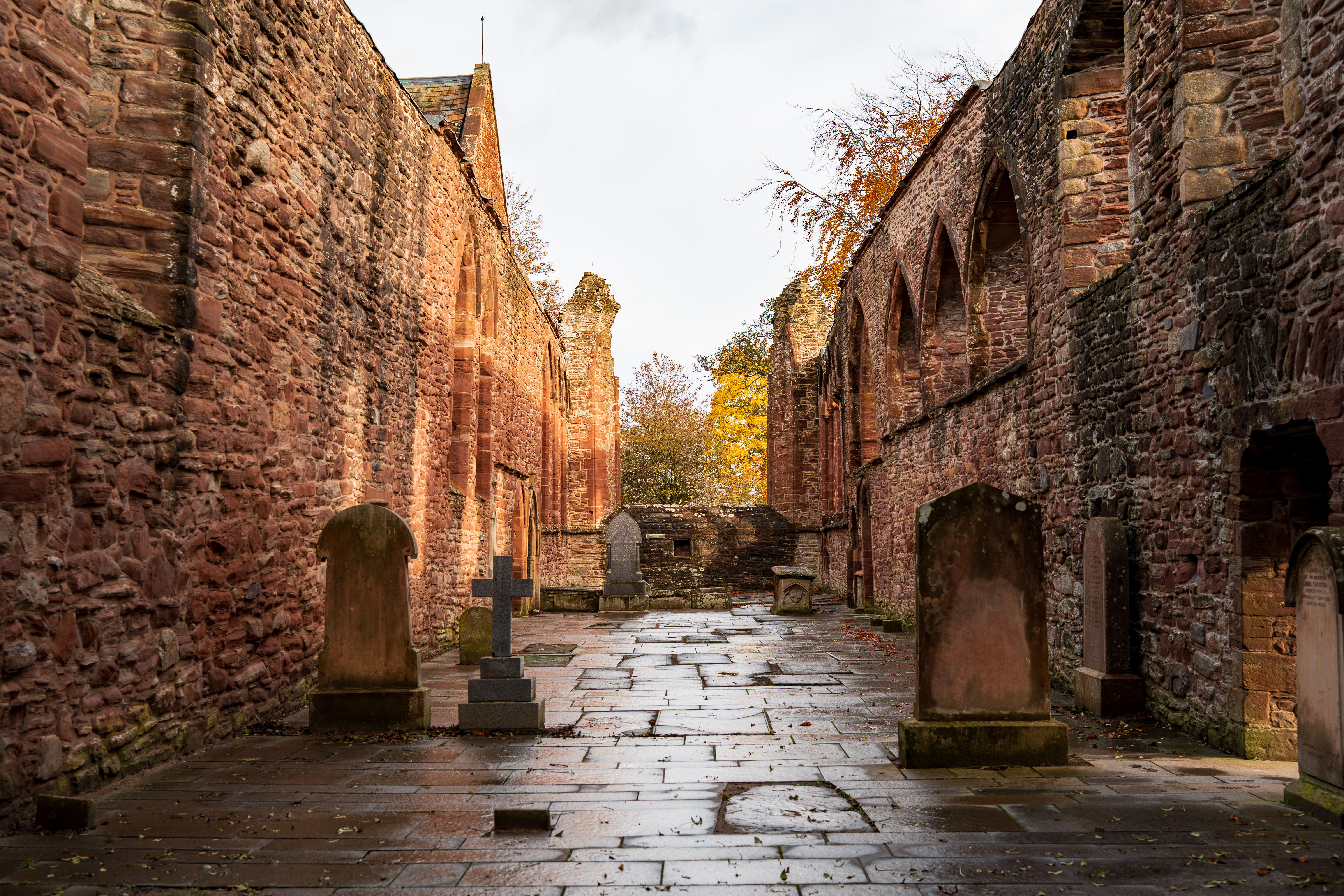 Flint and stone ruins of Reading Abbey with Forbury Gardens beyond