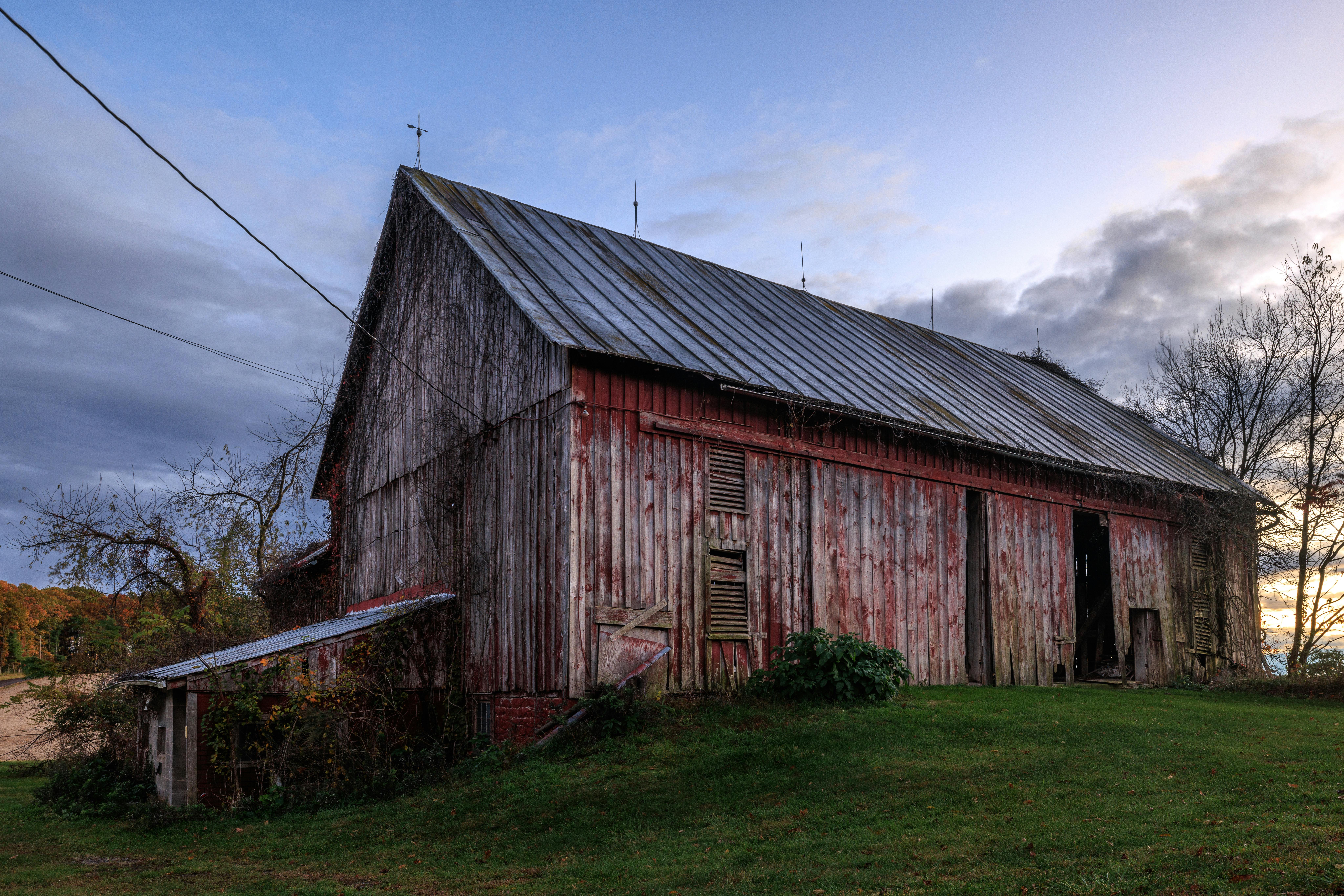 Scenic view of an old red barn in Williamsport, Pennsylvania during sunset.