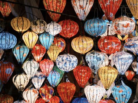 Colorful cluster of traditional Asian paper lanterns glowing beautifully.