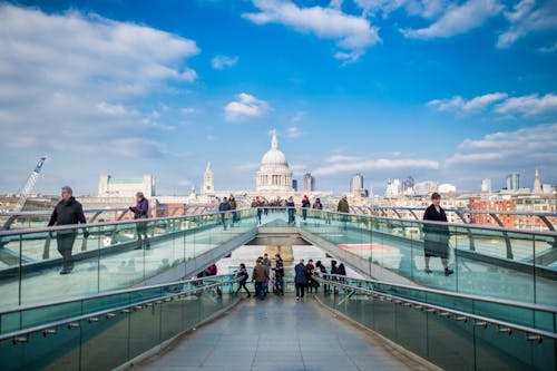 People Standing on Gray Bridge