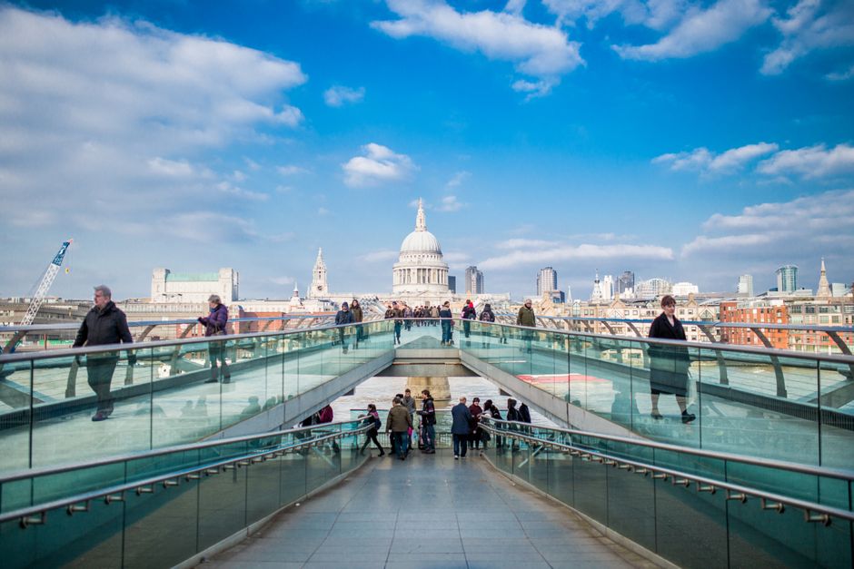 A vibrant scene on the Millennium Bridge with St. Paul's Cathedral in the background, London.
