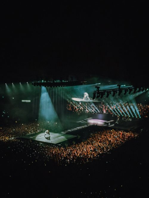 Free Vibrant concert featuring an artist on stage with immersive lighting and crowd engagement. Stock Photo