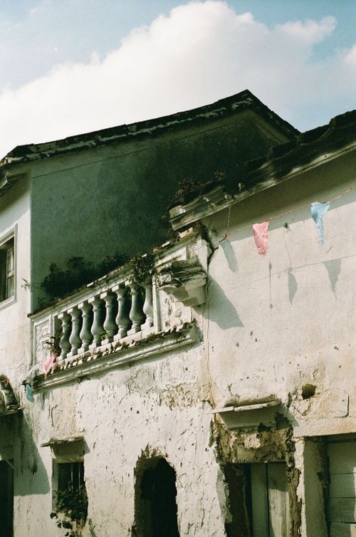Free A rustic, weathered house showcasing historical architecture with a vintage feel under a bright sky. Stock Photo