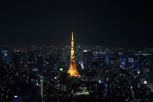 Stunning view of Tokyo Tower lit up, surrounded by the city's nightscape.