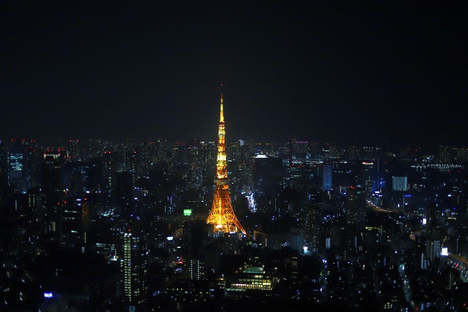 Stunning view of Tokyo Tower lit up, surrounded by the city's nightscape.