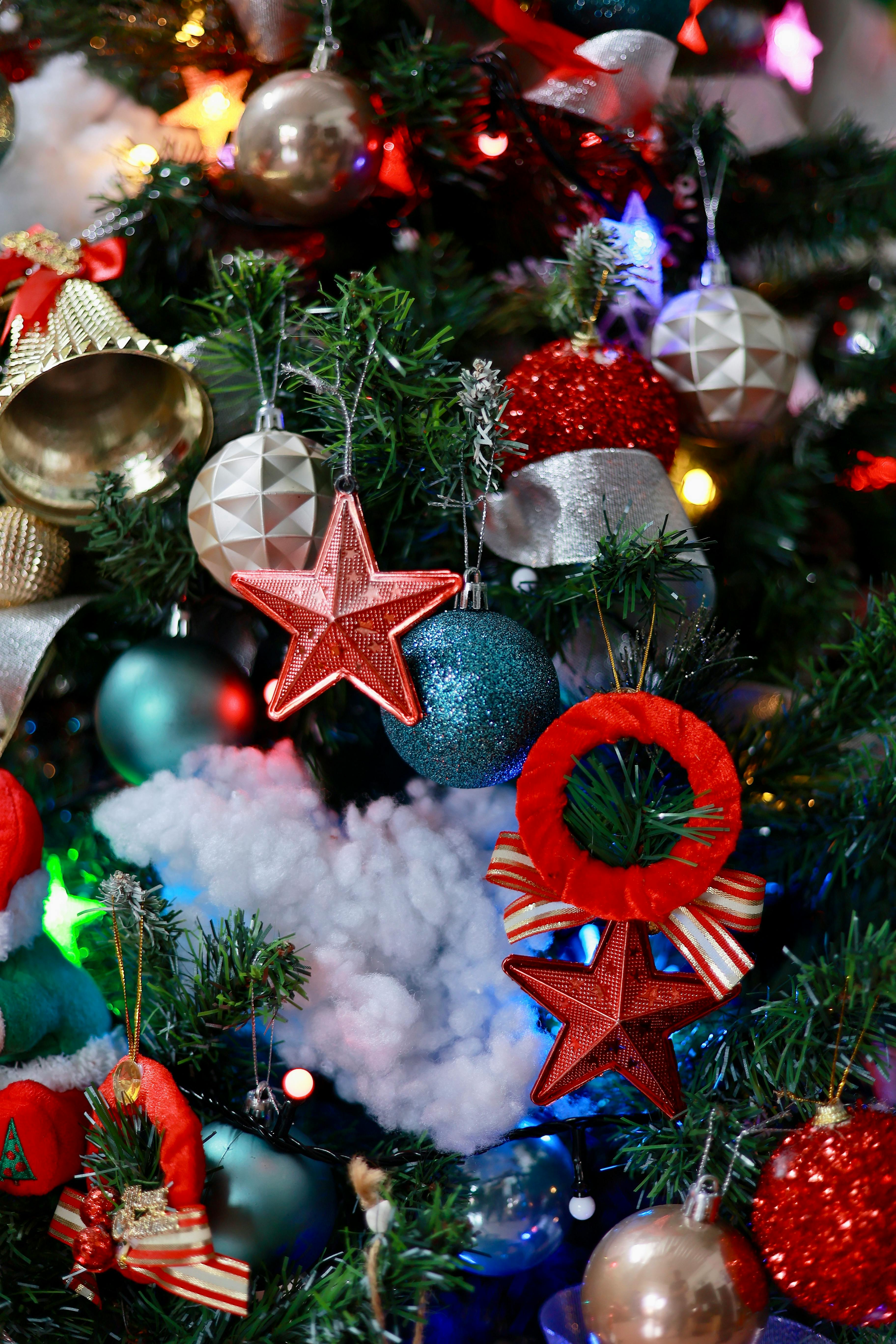 Close-up of a Christmas tree adorned with vibrant ornaments and lights, creating a festive holiday atmosphere.