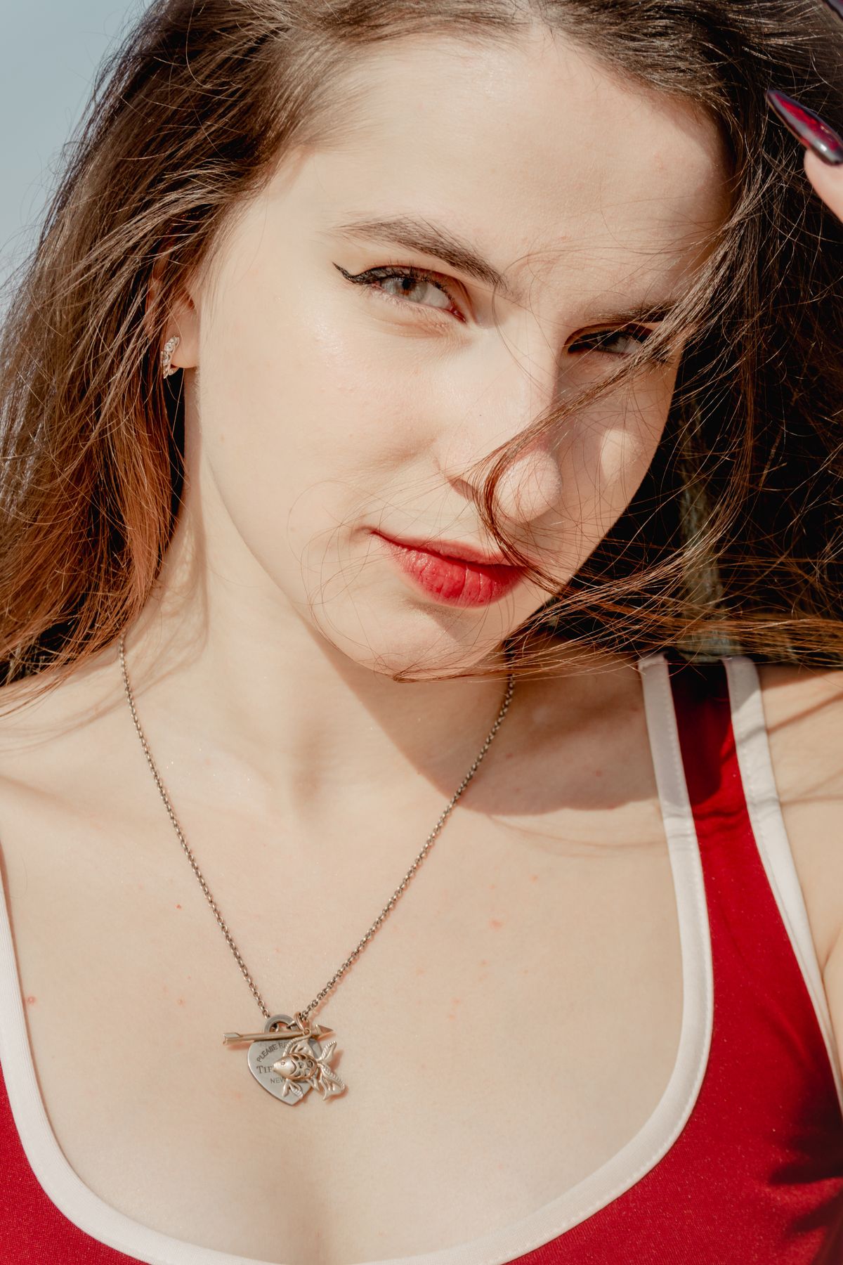 Young Woman in Red Top Posing Outdoors · Free Stock Photo