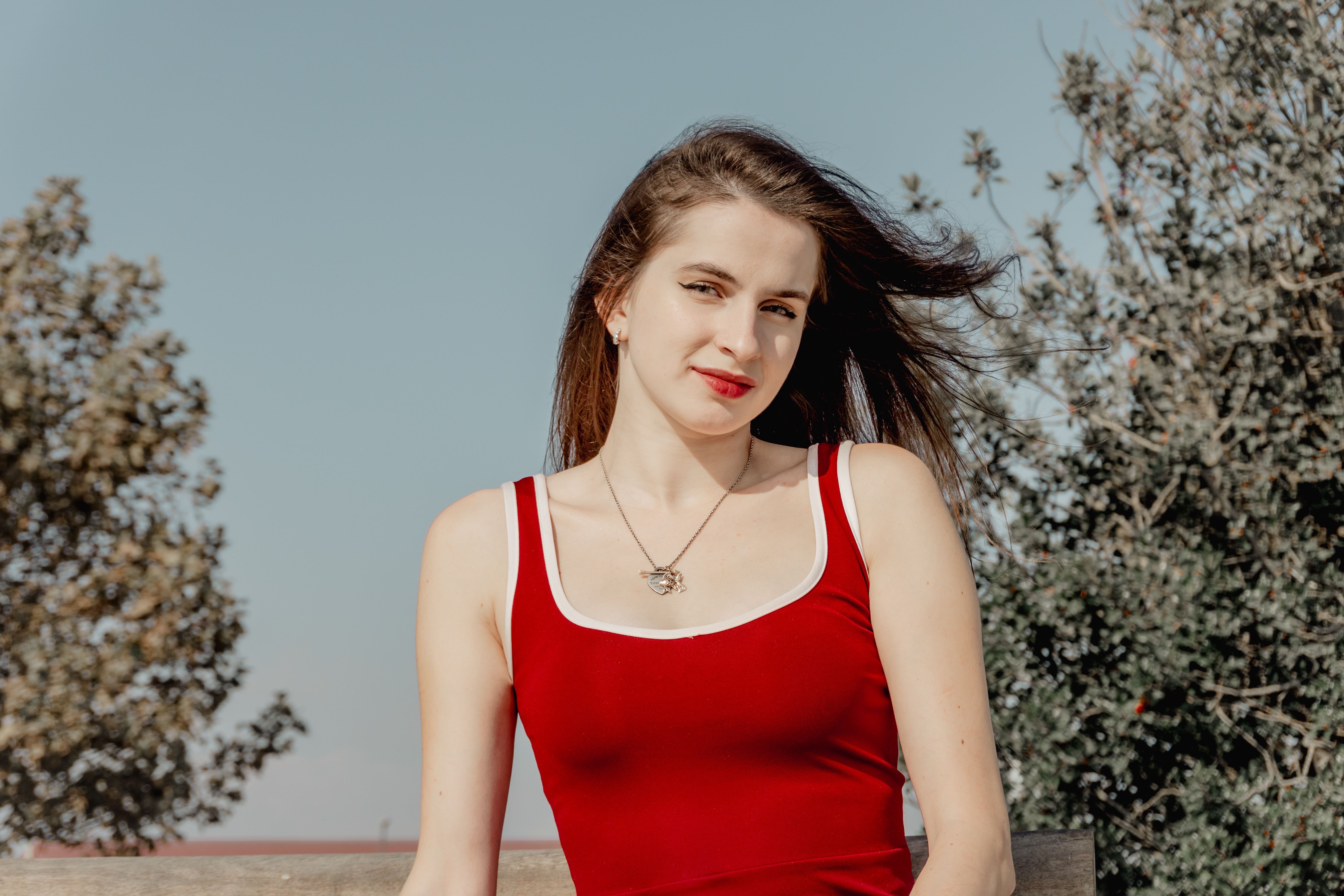 Confident Young Woman in Red Dress Outdoors · Free Stock Photo