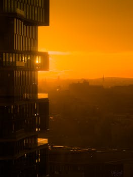 Captivating sunset view of Berlin's urban skyline with warm golden hues and silhouetted architecture.