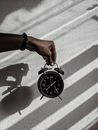 Person Holding a Alarm Clock