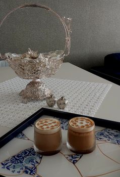 Luxurious coffee setup with intricate silver basket, perfect for upscale dining decor.