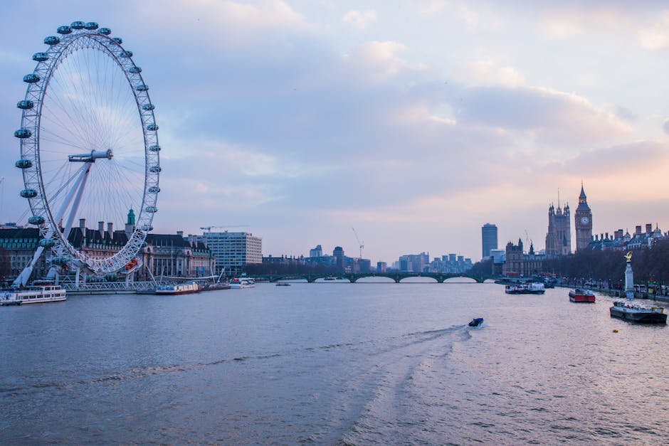 daytime view of the river thames and london eye with westminster palace in the background