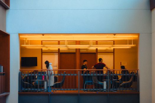 Group of professionals meeting in a modern office in Kingston, Ontario. Collaborative workspace.