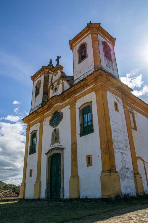 Free A historic Baroque church with twin towers against a bright blue sky, showcasing religious architecture. Stock Photo