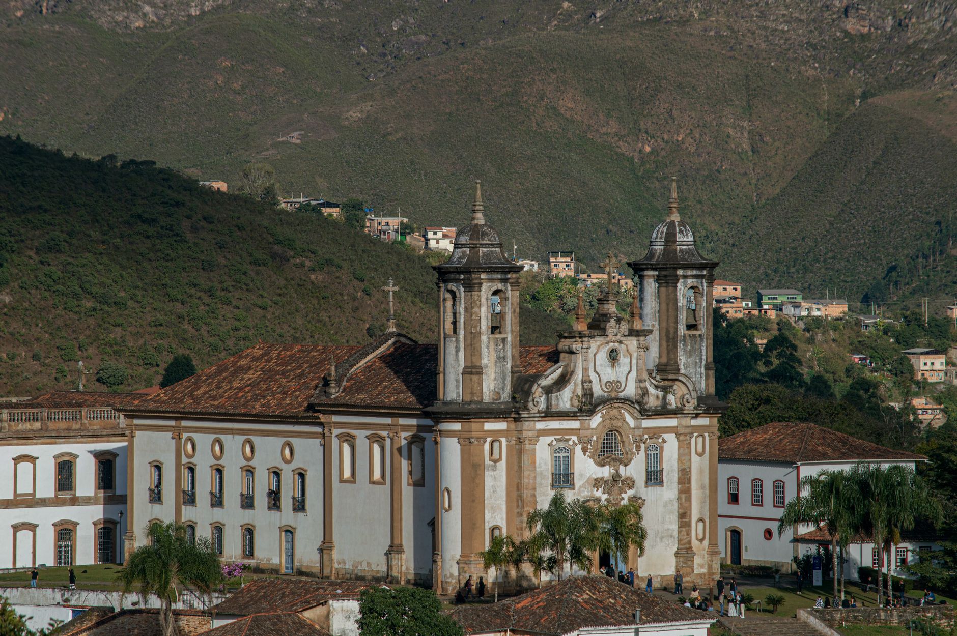 Baroque church surrounded by hills in historic Brazilian city, showcasing colonial architecture.