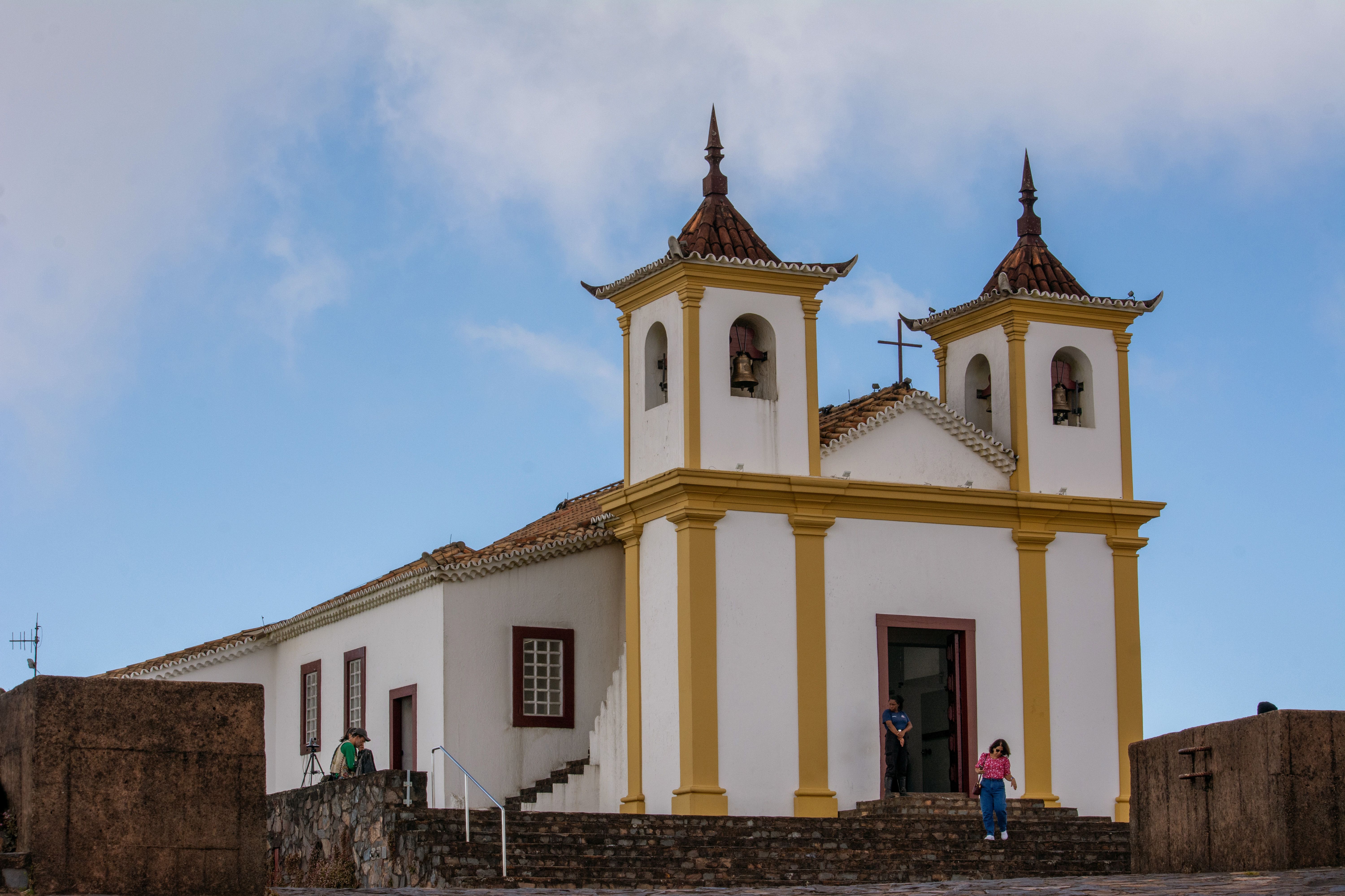 Historic Church with Twin Bell Towers Under Blue Sky · Free Stock Photo