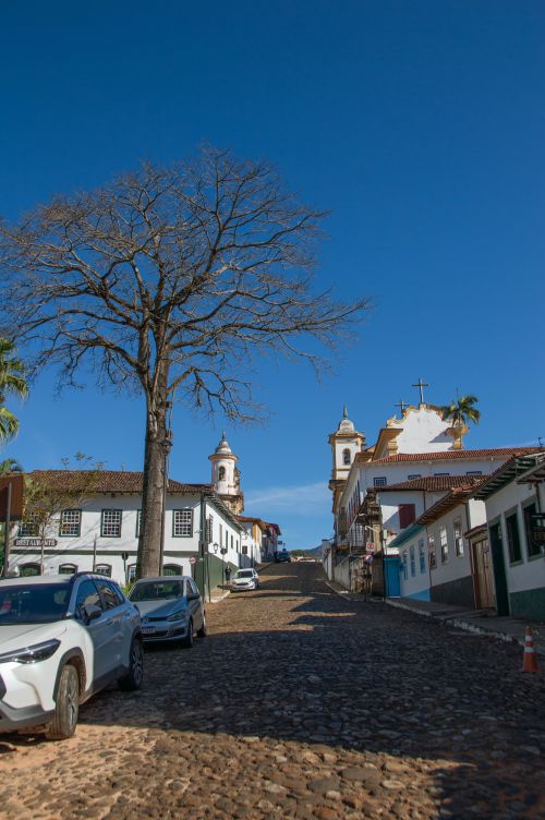 Free Cobblestone street in a historic city with colonial architecture and religious landmarks. Stock Photo