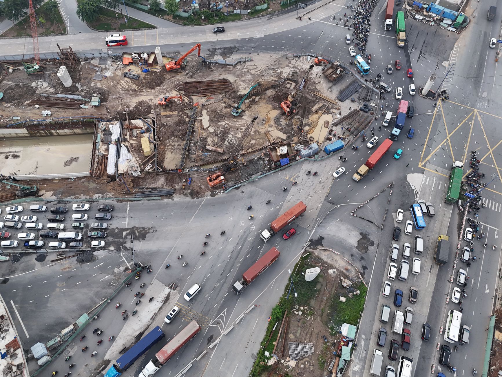Aerial photograph showcasing construction activity and heavy traffic at a busy city intersection.