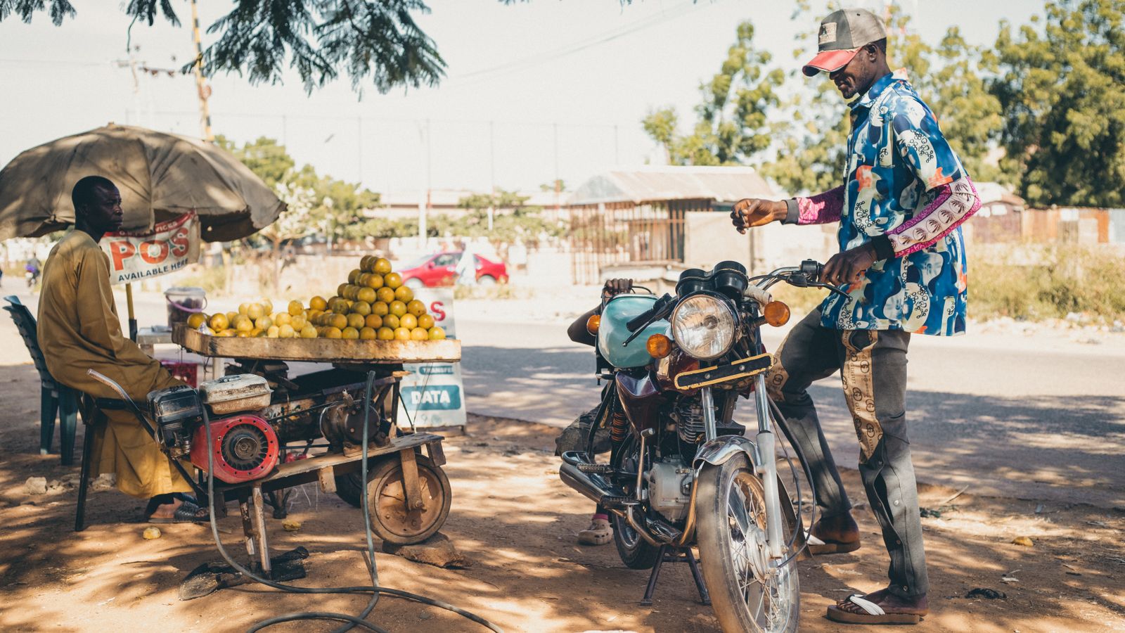 Street vendor selling lemons near motorbike, The Gambia