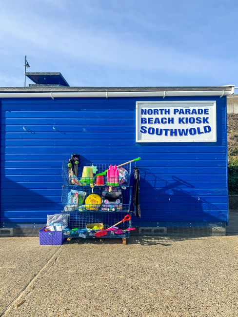 Vibrant beach kiosk with toys and gear in Southwold, England.