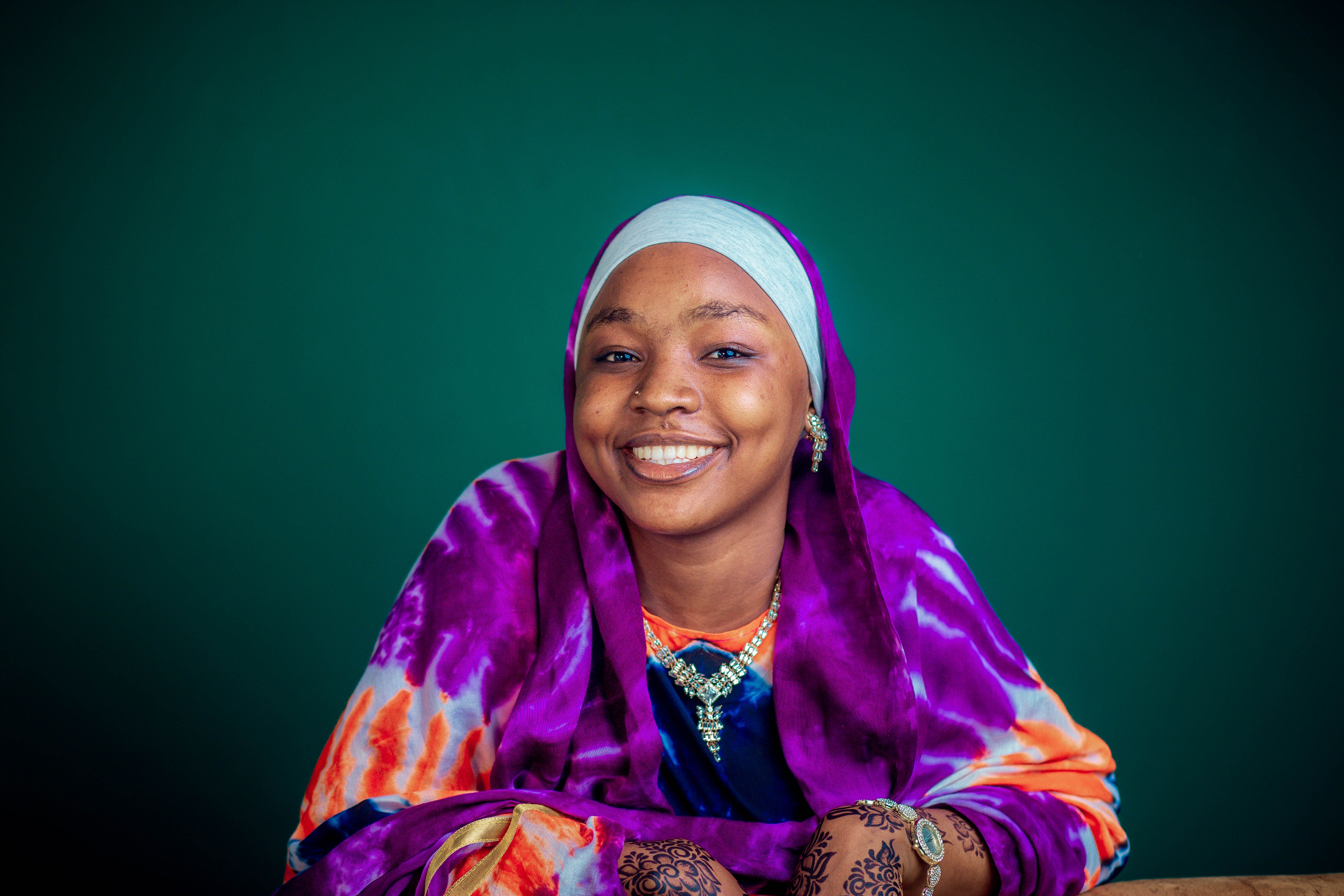 Smiling Woman in Colorful Traditional Attire · Free Stock Photo