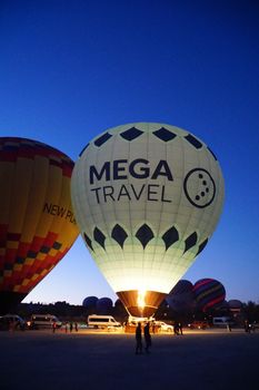 Majestic hot air balloons preparing for sunrise liftoff in Göreme, Turkey, capturing the spirit of adventure.