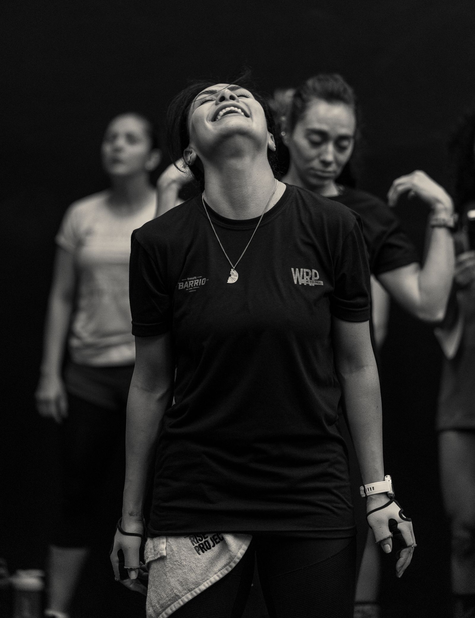 Friends working out together joyfully in a gym