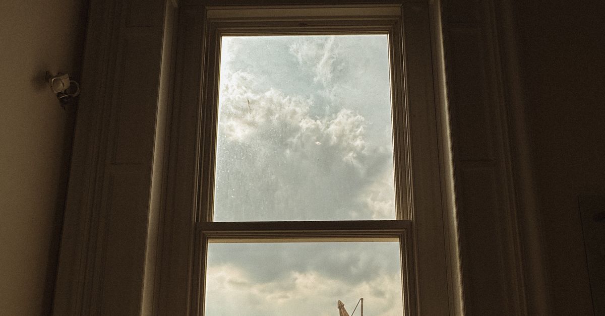 High View Window Tall Window View Overlooking Urban Rooftops · Free Stock Photo