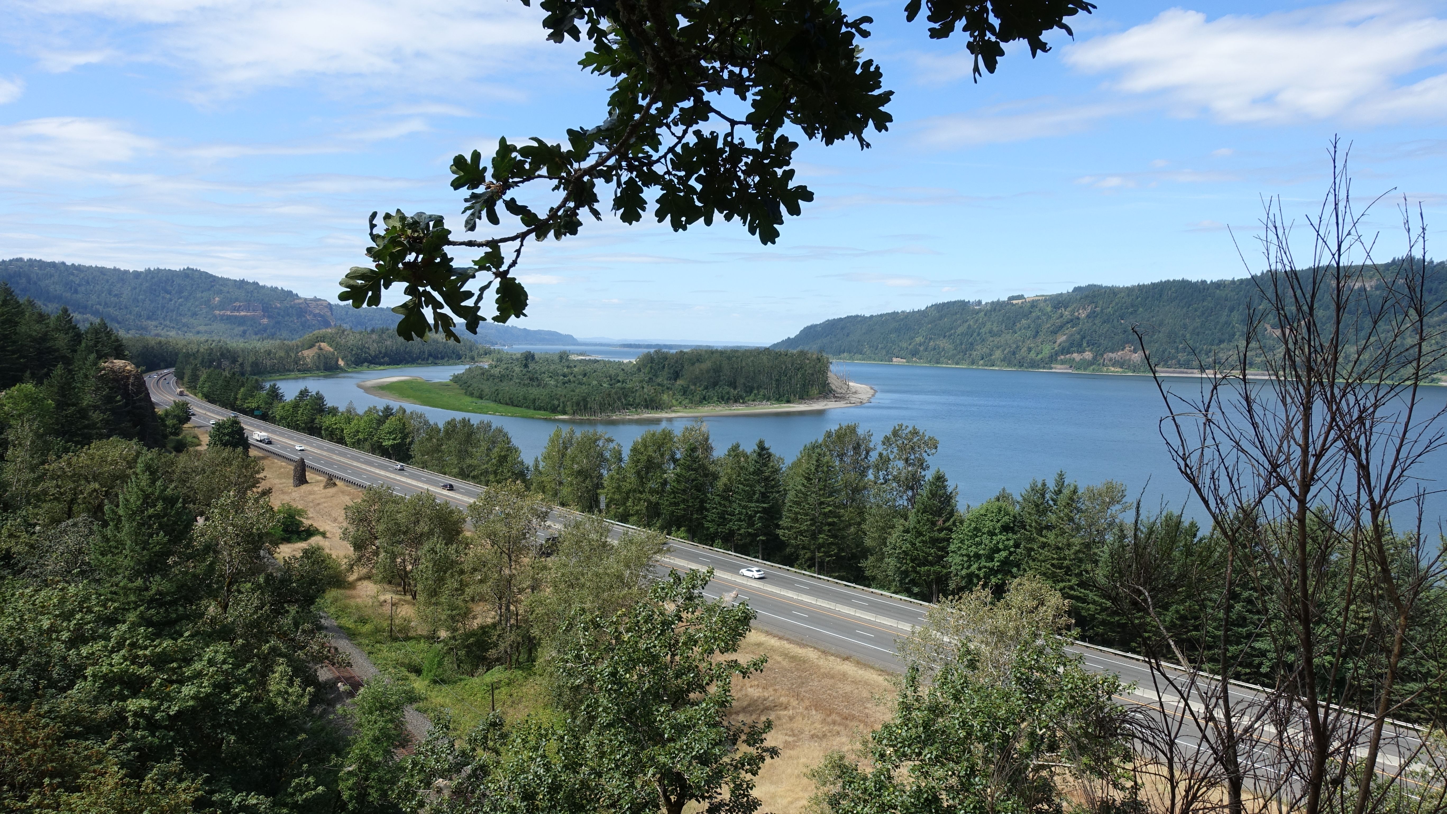 Scenic View of River Bordered by Forests and Highway · Free Stock Photo