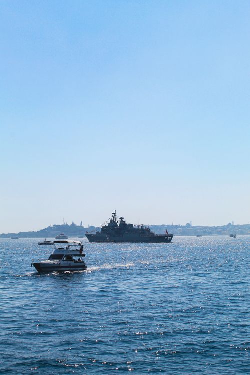 Free Tourist and military boats on Istanbul's Bosphorus under a clear blue sky. Stock Photo