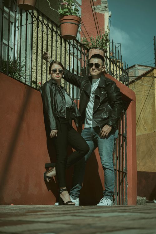 Free A couple in leather jackets poses stylishly in an alleyway in Guanajuato, Mexico. Stock Photo