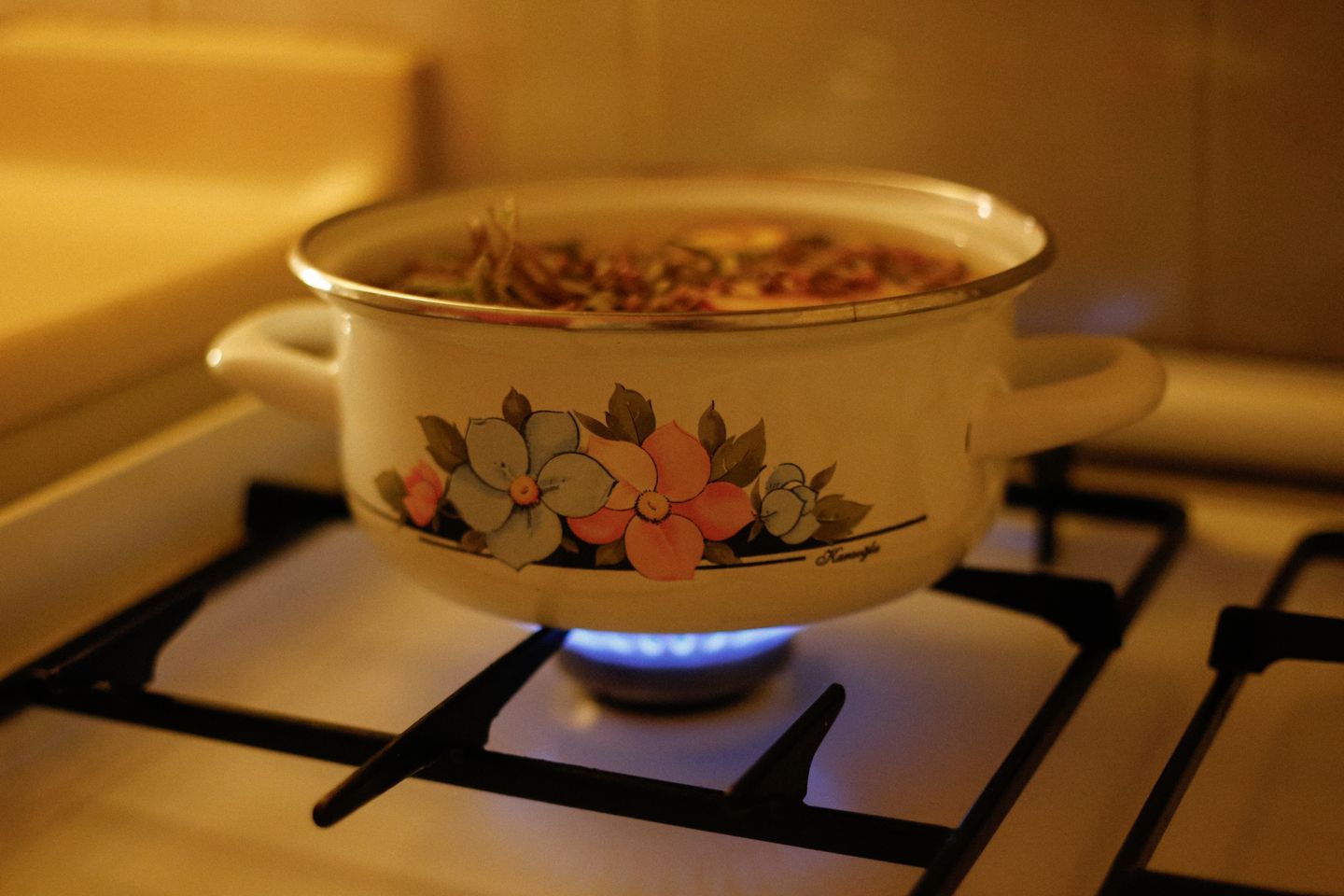 An enamelled pot on a low blue flame, with the kitchen warm and nobody in a hurry.