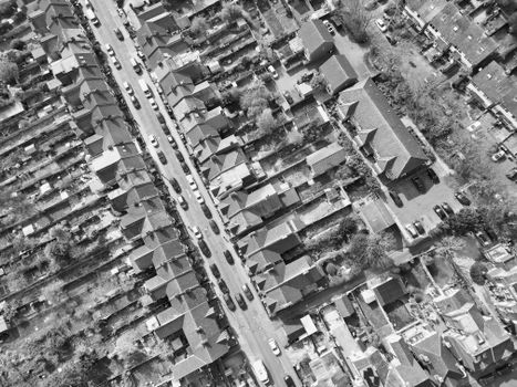 Black and white aerial shot of a residential neighborhood with lined houses.