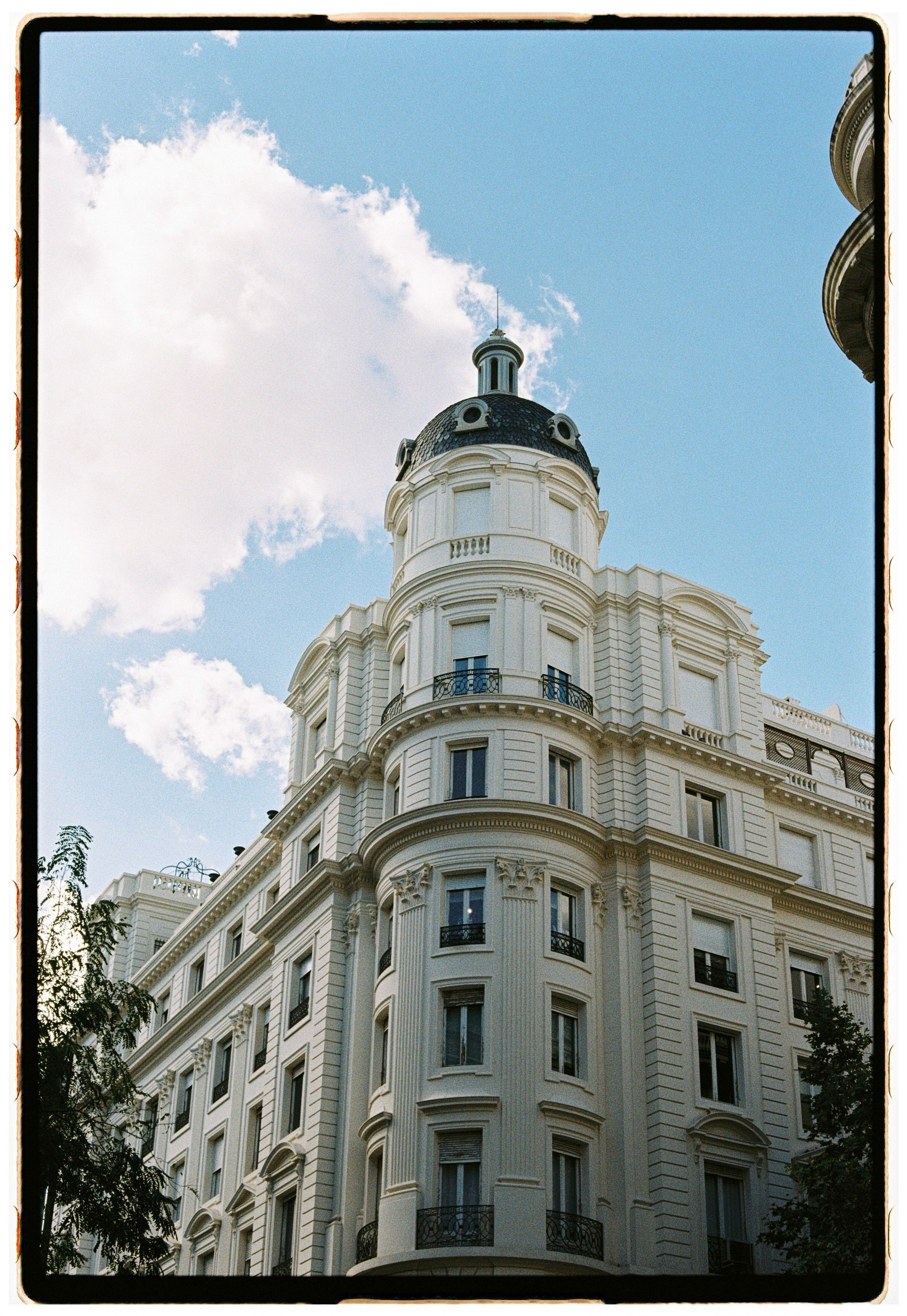 A historic building under a clear blue sky, showcasing classical architecture.