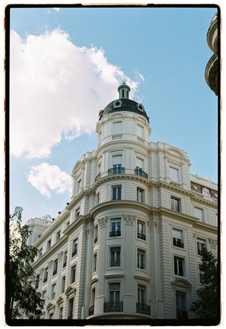 A historic building under a clear blue sky, showcasing classical architecture.