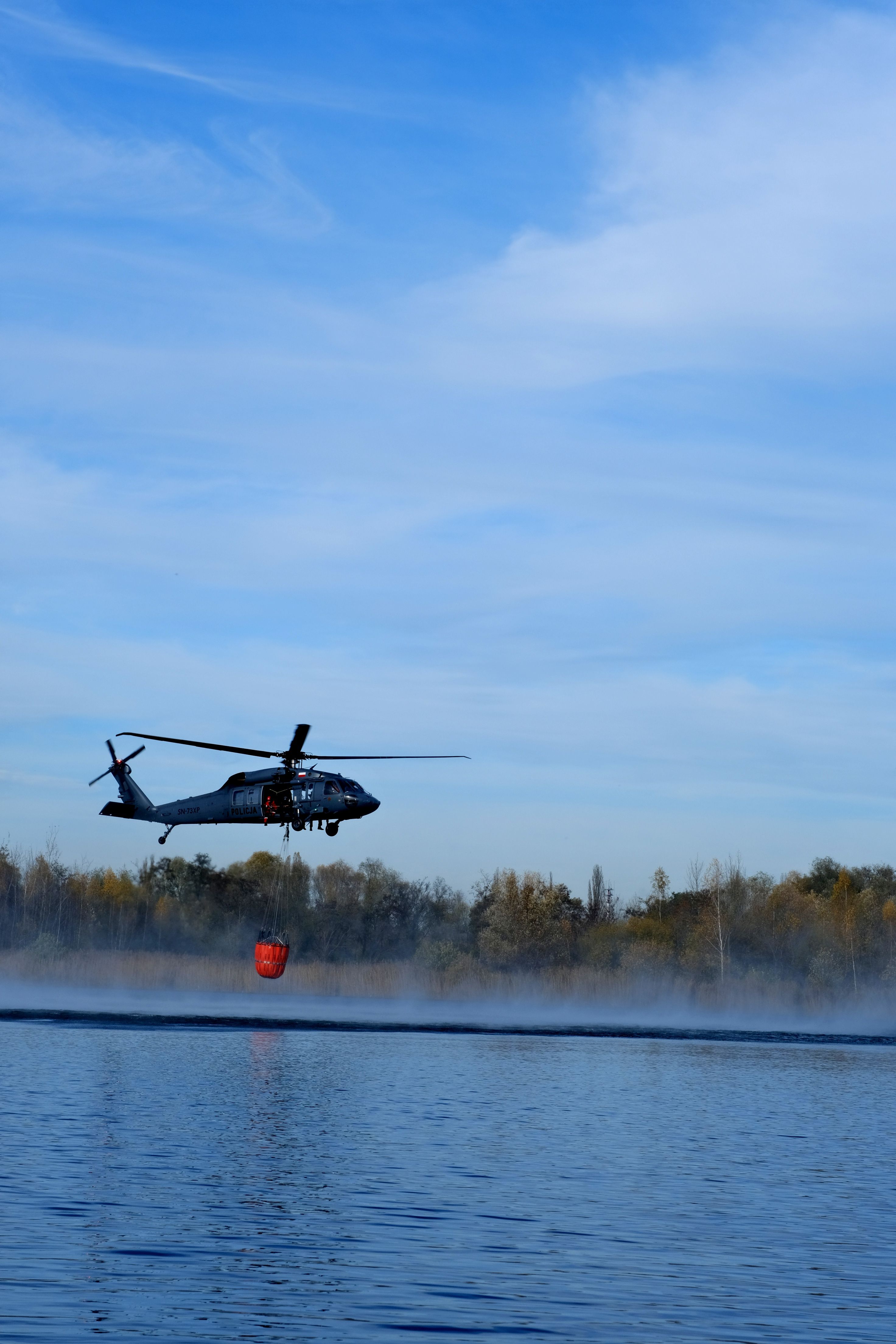 Helicopter Water Extraction Operation Over Lake · Free Stock Photo