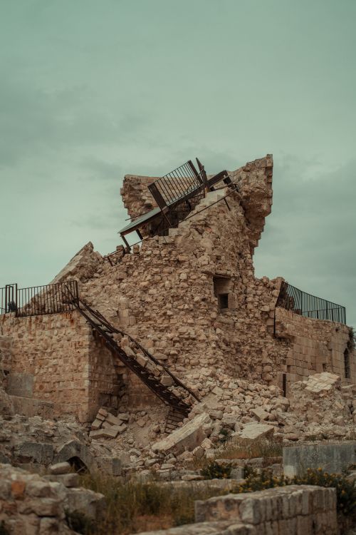 Free A dramatic capture of a ruined ancient fortress in Aleppo, Syria, showcasing historical architecture. Stock Photo